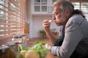 Grandpa in the kitchen with natural light, preparing for the day's dinner for the family. photo