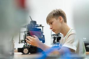 niños utilizando el mano robot tecnología, estudiantes son estudiando tecnología, cuales es uno de el vástago cursos foto