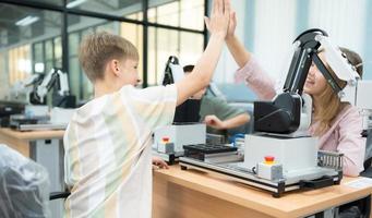 Children using the hand robot technology and having fun Learning, Students are studying technology, which is one of the STEM courses. photo