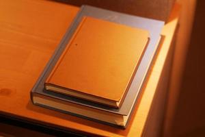 stack of books on wooden table photo