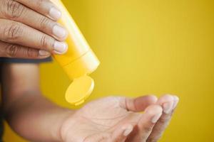 young men using sunscreen cream photo