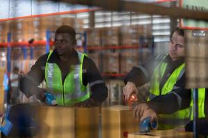 Group of worker in auto parts warehouse Packing small parts in boxes after inspecting the car parts that are ready to be sent to the car assembly plant. photo