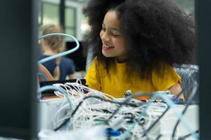 Children using the hand robot technology and having fun Learning the electronic circuit board of hand robot technology, which is one of the STEM courses. photo