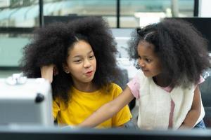 Children using the hand robot technology and having fun Learning the electronic circuit board of hand robot technology, which is one of the STEM courses. photo