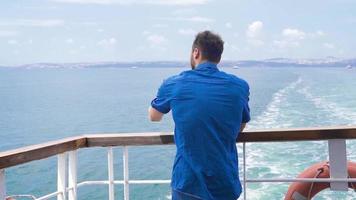 Teenager traveling on cruise ship talking on phone. Slow Motion. Young man talking on the phone in the middle of the sea. video