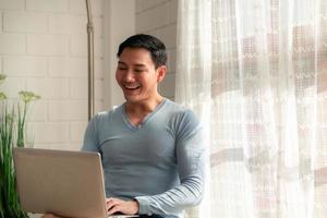 LGBT Young men use computers to communicate with their peers. on the days at home cannot go out. photo