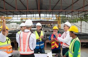 Construction engineers, architects, and foremen form a group. Participate in a meeting to plan new construction projects. Cheers to express happiness that the event was successfully accomplished. photo