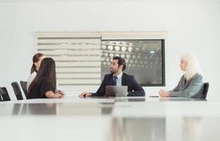 In the company meeting room Young executives are brainstorming ideas about a new business that will launch big soon. photo