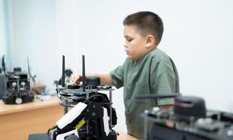 Youngsters utilizing the hand robot technology are having fun learning the hand robot controller of robot technology, which is one of the STEM courses. photo