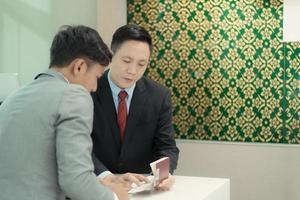 Airline ground staff help passengers check their tickets and passports for travel. photo