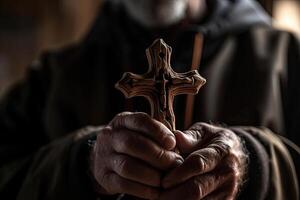 Church priest holds religious cross in hands. photo