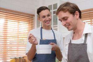 A young couple enters the kitchen to prepare dinner for celebrating the anniversary of being together for many years photo