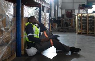 Head of worker in an auto parts warehouse, Sit back and relax after examine auto parts that are ready to be shipped to the automobile assembly factory. photo