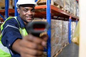 Head of worker in an auto parts warehouse, Examine auto parts that are ready to be shipped to the automobile assembly factory. photo