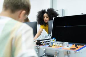 Youngsters utilizing the hand robot technology are having fun learning the electronic circuit board and hand robot controller of robot technology, which is one of the STEM courses. photo