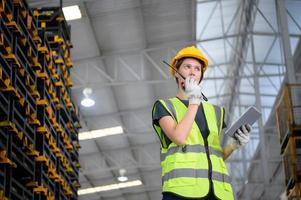 Female worker in an auto parts warehouse, Examine auto parts that are ready to be shipped to the automobile assembly factory. photo