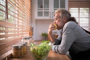 Grandpa in the kitchen with natural light, preparing for the day's dinner for the family. photo