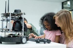 Youngsters utilizing the hand robot technology are having fun learning the electronic circuit board and hand robot controller of robot technology, which is one of the STEM courses. photo