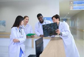 Medical teacher and interns analyzing the x-ray results of the patient's brain. before major surgery in the operating room photo