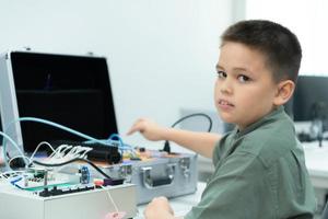 jovenes utilizando el mano robot tecnología son teniendo divertido aprendizaje el electrónico circuito tablero y mano robot controlador de robot tecnología, cuales es uno de el vástago cursos foto