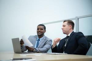 Businessmen with a meeting of the new management team with information comment finding common conclusions photo