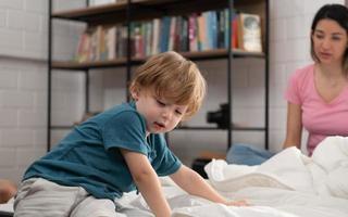 After the little boy wakes up from his nap, his father and mother engage in enjoyable activities in his bedroom. photo