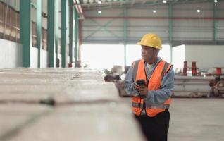 Workers inspect the new warehouse's products. Use barcode scanners to check the products that will be used in the warehouse shelf structure. photo