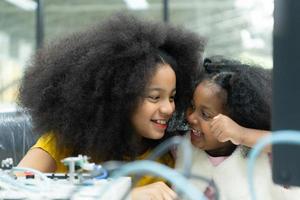 Children using the hand robot technology and having fun Learning the electronic circuit board of hand robot technology, which is one of the STEM courses. photo