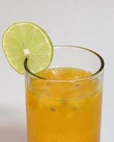 Closeup glass of passionfruit, maracuya juice. Healthy drinks concept photo
