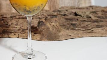 Closeup glass of passionfruit, maracuya juice. Healthy drinks concept photo