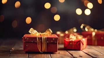 Christmas presents wrapped in red paper with gold ribbon on on wooden table background and bokeh. Place for typography and logo. Copy space. . photo