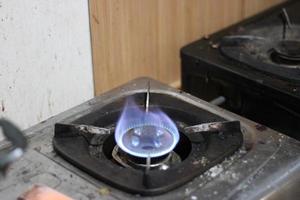 photo of gas stove lighting blue flame