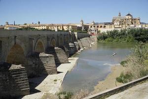 Roman Bridge on Guadalquivir River and Mezquita Mosque - Cathedral in Cordoba, Spain photo