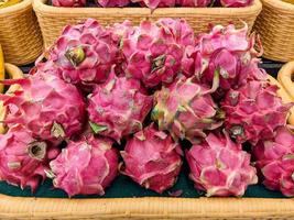 red dragon fruit on the market shelf. healthy fruit concept photo