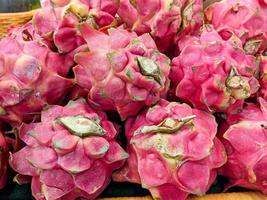 red dragon fruit on the market shelf. healthy fruit concept photo