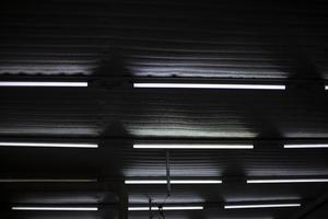 Fluorescent lamps. Ceiling in production room. Light in stock. photo