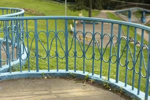 Fence in park. Blue fence. Details of park architecture. Wrought iron. photo