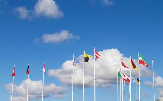 Several flags of German federal states waving in the wind against a sunny sky photo