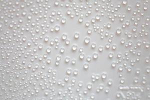 small fine round droplets on a white background photo