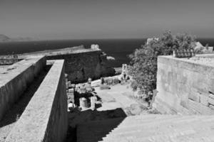 old antique stone ruins on a hot summer day on the Greek island of Rhodes in Lindos photo