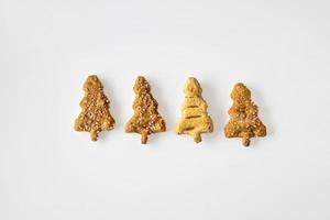 sweet cakes with sugar and cinnamon in the shape of a Christmas tree on a white isolated background photo