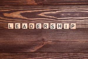 Leader, leadership, lead word on wooden background photo