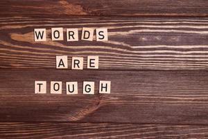 Words are tough phrase, message, on wooden background photo