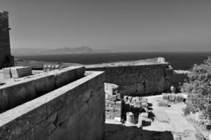 old antique stone ruins on a hot summer day on the Greek island of Rhodes in Lindos photo