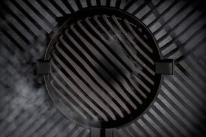 Top view of smoking smouldering charcoals under black cast iron grill grate ready for food cooking photo