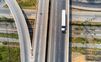 Aerial view of cargo white Truck on highway road with container, transportation concept.,import,export logistic industrial Transporting Land transport on the asphalt expressway photo