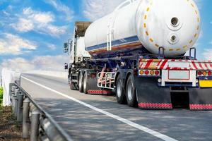 Gas Truck on highway road with tank oil  container, transportation concept.,import,export logistic industrial Transporting Land transport on the asphalt expressway with blue sky photo