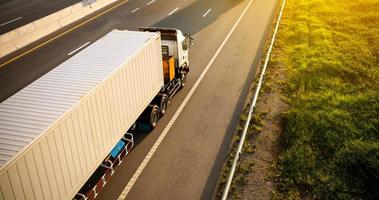 White Truck on highway road with container, transportation concept.,import,export logistic industrial Transporting Land transport on the expressway.motion blurred to soft focus photo