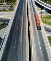 Aerial view of cargo Truck on highway road with red container, transportation concept.,import,export logistic industrial Transporting Land transport on the asphalt expressway photo