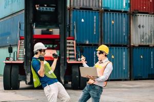 Team Engineer and worker wear safety uniform check control loading freight cargo container use computer laptop at commercial dock warehouse,transportation import,export logistic industrial service photo